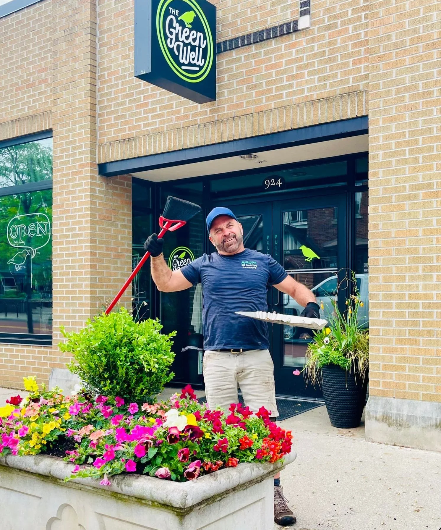Pondless waterfall feature with red flowers